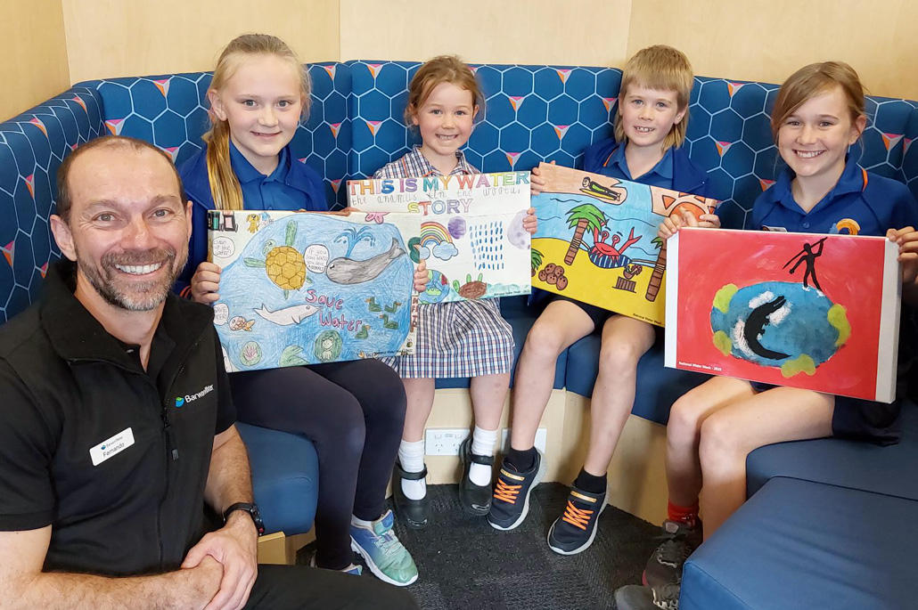 Education Officer Fernando Garcia with Torquay Coast Primary School students and their National Water Week posters. Left to right: Maia V, Indi B, Josh S and Matilda M.